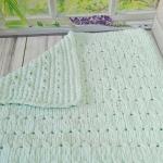 Patterned baby blanket made with knitted and plush (puffy) yarn