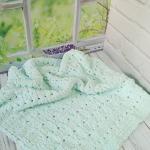 Patterned baby blanket made with knitted and plush (puffy) yarn