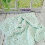 Patterned baby blanket made with knitted and plush (puffy) yarn