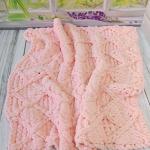 Patterned baby blanket made with knitted and plush (puffy) yarn