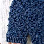 Hand-knitted baby romper and hat set. Embossed and bud-patterned.