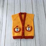 Hand-knitted, lion-themed, yellow and red baby cardigan