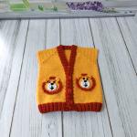 Hand-knitted, lion-themed, yellow and red baby cardigan